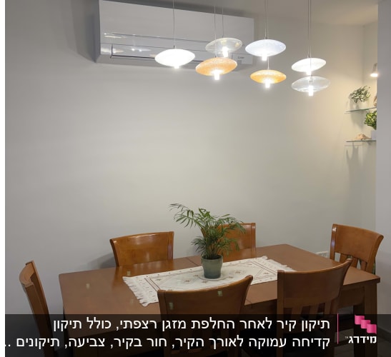 פינת אוכל עם שולחן עץ וכיסאות, תאורה תלויה ומזגן על הקיר